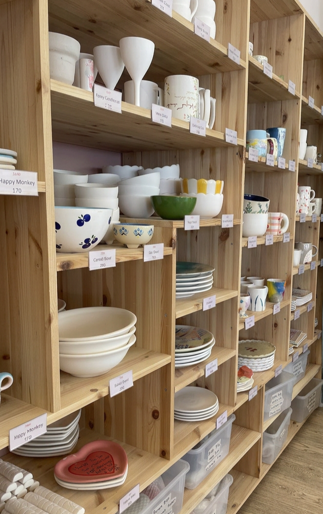 Choosing a ceramic piece from the studio shelves
